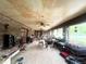 Enclosed patio with brick walls, tile floors, ceiling fans, and furniture at 3725 Blossom St, Kissimmee, FL 34746