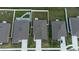 Drone shot of the homes in a community showcasing backyard layouts, rooftops, and driveways at 381 Singing Sands Cir, Lake Wales, FL 33859