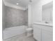 Bathroom featuring a shower-tub combo with gray tiling and a single sink vanity at 381 Singing Sands Cir, Lake Wales, FL 33859