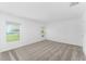 Bedroom with neutral carpet, windows offering a view of the outdoors, and bright, freshly painted walls at 381 Singing Sands Cir, Lake Wales, FL 33859