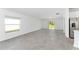 Spacious living room with large windows, sliding doors, and neutral-colored tile floors at 381 Singing Sands Cir, Lake Wales, FL 33859