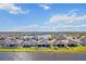 Gorgeous aerial view of lakeside homes surrounded by lush lawns and white fences in a Gathering-friendly neighborhood at 3848 Cabo Rojo Dr, St Cloud, FL 34772