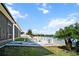 Inviting backyard features a stone patio, lush lawn, and serene waterfront views for relaxing or entertaining at 3848 Cabo Rojo Dr, St Cloud, FL 34772