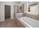 Bathroom featuring tile flooring, a soaking tub, and a glass enclosed shower at 3848 Cabo Rojo Dr, St Cloud, FL 34772