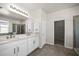 Primary bathroom featuring a dual sink vanity, large mirror, and tub at 3848 Cabo Rojo Dr, St Cloud, FL 34772