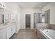 Bathroom featuring dual sink vanity, tub, and glass enclosed shower at 3848 Cabo Rojo Dr, St Cloud, FL 34772