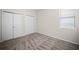 Bedroom with neutral carpeting, window with blinds, and closet with sliding doors at 3848 Cabo Rojo Dr, St Cloud, FL 34772