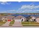 Beautiful lakeside homes feature well-manicured lawns, two car garages, and lovely landscaping with lake views at 3848 Cabo Rojo Dr, St Cloud, FL 34772