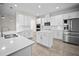 Bright kitchen featuring white cabinets, stainless steel appliances, and quartz countertops at 3848 Cabo Rojo Dr, St Cloud, FL 34772