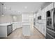 Bright kitchen featuring white cabinets, stainless steel appliances, and quartz countertops at 3848 Cabo Rojo Dr, St Cloud, FL 34772