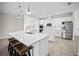 Kitchen with white cabinets, quartz countertops, stainless steel appliances, and bar seating at 3848 Cabo Rojo Dr, St Cloud, FL 34772