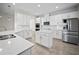 Bright kitchen featuring white cabinets, stainless steel appliances, and quartz countertops at 3848 Cabo Rojo Dr, St Cloud, FL 34772