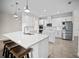 Kitchen with white cabinets, quartz countertops, stainless steel appliances, and bar seating at 3848 Cabo Rojo Dr, St Cloud, FL 34772
