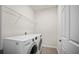 Laundry room with white washer, dryer, shelving, and tiled floor at 3848 Cabo Rojo Dr, St Cloud, FL 34772