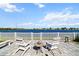 Outdoor patio furniture with seating and bench with scenic view of the lake at 3848 Cabo Rojo Dr, St Cloud, FL 34772