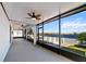 Relaxing screened lanai with ceiling fans offers panoramic waterfront views and leads to an inviting outdoor patio at 3848 Cabo Rojo Dr, St Cloud, FL 34772
