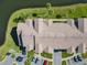 An aerial view of the apartments showcasing pristine landscaping, pond views, and ample parking at 4105 Tropical Isle Blvd # 222, Kissimmee, FL 34741