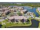 Community aerial view featuring a serene lake, lush landscaping, and ample parking at 4105 Tropical Isle Blvd # 222, Kissimmee, FL 34741