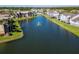 A serene aerial view shows the community with a central lake featuring a fountain and lush green landscaping at 4105 Tropical Isle Blvd # 222, Kissimmee, FL 34741