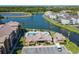 Aerial view of community clubhouse with pool, parking, and picturesque lake views at 4105 Tropical Isle Blvd # 222, Kissimmee, FL 34741