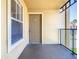 Condo balcony featuring a tan door and siding with a black railing at 4105 Tropical Isle Blvd # 222, Kissimmee, FL 34741