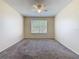 Cozy bedroom with neutral carpet and a ceiling fan at 4105 Tropical Isle Blvd # 222, Kissimmee, FL 34741