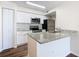 Modern kitchen with stainless steel appliances, granite countertops, and white cabinetry at 4105 Tropical Isle Blvd # 222, Kissimmee, FL 34741