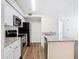 Open kitchen features stainless steel appliances, granite countertops and white cabinets at 4105 Tropical Isle Blvd # 222, Kissimmee, FL 34741