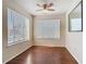 Living room featuring hardwood floors, ceiling fan, and multiple windows for natural light at 4105 Tropical Isle Blvd # 222, Kissimmee, FL 34741