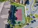 Aerial view of community tennis court surrounded by lush green landscaping and parking at 4105 Tropical Isle Blvd # 222, Kissimmee, FL 34741