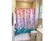Bathroom featuring a mermaid themed shower curtain, creating a fun and playful space at 4441 Shiva Loop, Kissimmee, FL 34746