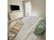 Cozy bedroom with a large window, plush bedding, and a dresser with TV, offering a comfortable and relaxing retreat at 4441 Shiva Loop, Kissimmee, FL 34746