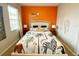 Bright bedroom featuring vibrant colors, patterned bedding, and bedside tables at 4441 Shiva Loop, Kissimmee, FL 34746