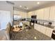 Well-equipped kitchen with stainless steel appliances, granite countertops, and breakfast bar at 4441 Shiva Loop, Kissimmee, FL 34746