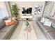 Comfortable living room featuring neutral decor, sofas, and entertainment center at 4441 Shiva Loop, Kissimmee, FL 34746