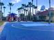 Community basketball court with playground in background surrounded by swaying palm trees at 4726 Ormond Beach Way, Kissimmee, FL 34746
