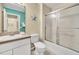 Cozy bathroom featuring a shower with glass doors, a toilet, and a stylish sink at 4726 Ormond Beach Way, Kissimmee, FL 34746