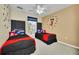 Lovely bedroom featuring two beds with Mickey Mouse decor, a ceiling fan, and a window at 4726 Ormond Beach Way, Kissimmee, FL 34746