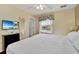 Comfortable bedroom offering lake views, a TV and ample natural light at 4726 Ormond Beach Way, Kissimmee, FL 34746