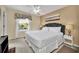 Main bedroom with a view of the lake, natural lighting, and decorative window treatment at 4726 Ormond Beach Way, Kissimmee, FL 34746
