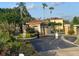 Community entrance with palm trees, lush landscaping, and controlled access at 4726 Ormond Beach Way, Kissimmee, FL 34746