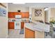 Well-lit kitchen featuring white appliances, tiled floors and plenty of cabinet space at 4726 Ormond Beach Way, Kissimmee, FL 34746