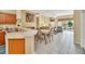 Open-concept living and dining area with tile floors and access to outdoor patio at 4726 Ormond Beach Way, Kissimmee, FL 34746