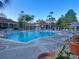 Large community pool with lounge chairs, a gazebo, and swaying palm trees at 4726 Ormond Beach Way, Kissimmee, FL 34746