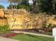 Terra Verde's entrance sign with beautiful stonework and landscaping at 4726 Ormond Beach Way, Kissimmee, FL 34746