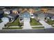 New two-story home features professional landscaping, front-entry two car garage, and modern exterior colors at 606 Bell Prairie Cir, Lake Wales, FL 33859