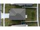 Aerial view of the house showcasing its roof, driveway, and a well-maintained lawn at 606 Bell Prairie Cir, Lake Wales, FL 33859
