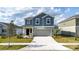 Charming two-story home featuring a covered entry, two-car garage, and beautifully landscaped front yard at 606 Bell Prairie Cir, Lake Wales, FL 33859