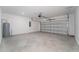 Spacious two-car garage with concrete floor and a garage door opener, plus a water heater and electric panel at 606 Bell Prairie Cir, Lake Wales, FL 33859