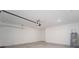 Spacious garage with concrete floor, white walls, and water heater at 606 Bell Prairie Cir, Lake Wales, FL 33859